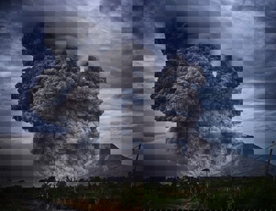 A volcano erupting with a huge ash cloud