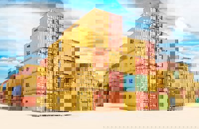 A pile of yellow and orange shipping containers