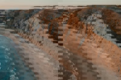 Aerial view of sandy beach and cliffs