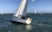 People on a sailing boat on a calm sea.