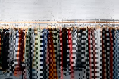 A clothing rail containing trousers and shorts of different colours