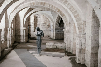 Statue Of Person Holding Bowl In Church