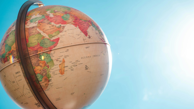 A globe showing Africa, the Middle East and south Asia stands still as the sun beams on its surface. the reminder of what can be seen is the blue sky